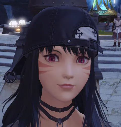 A close-up of a black-haired Miqo’te in a backwards cap decorated with crosses and two chokers.